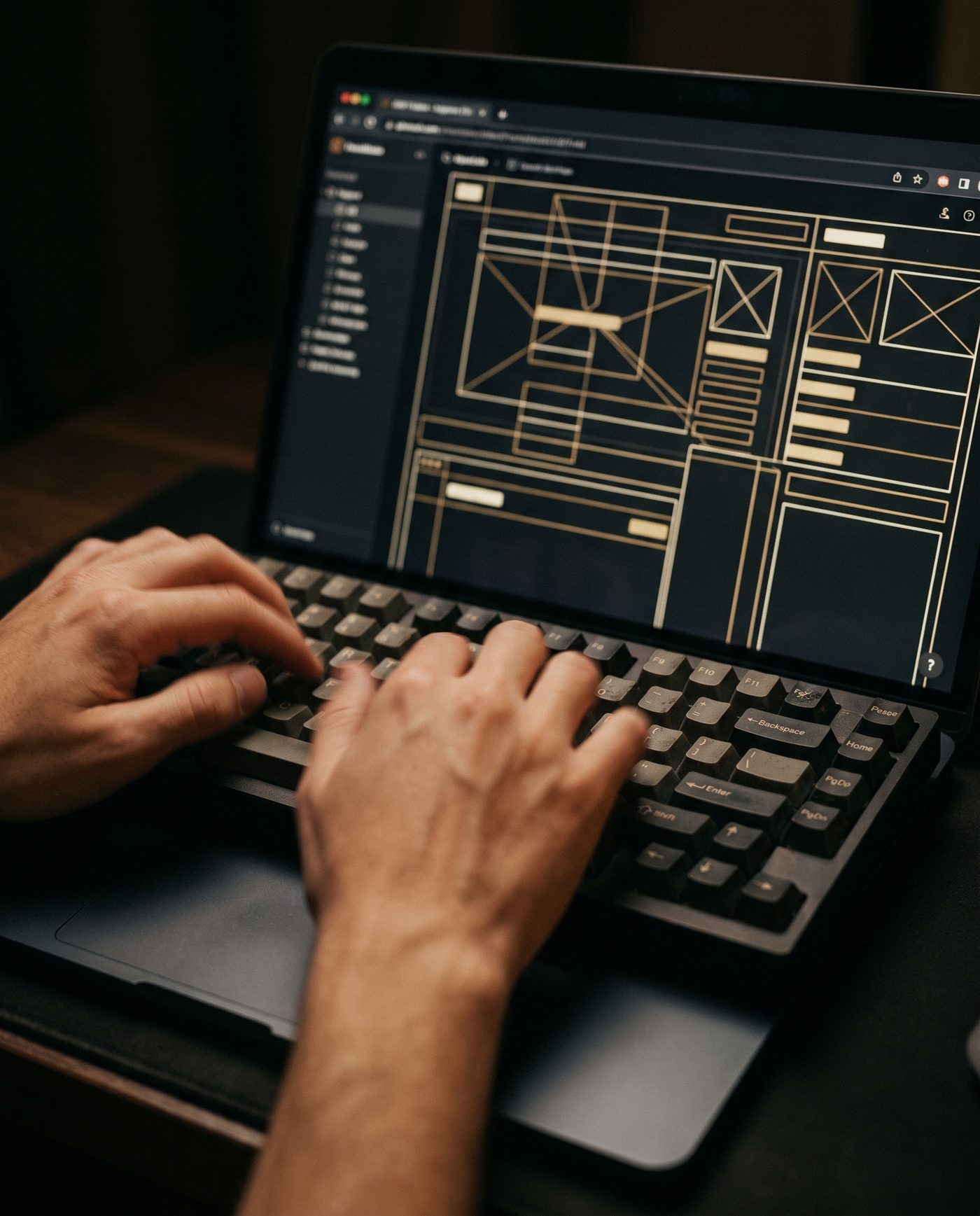 Laptop screen showing an abstract dark-mode website wireframe